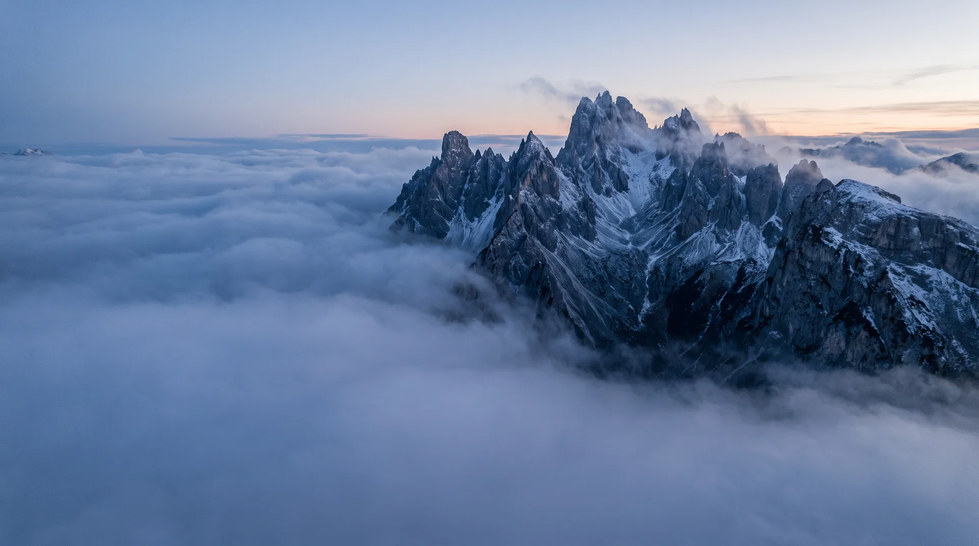 Alpine ridge rising above a sea of clouds